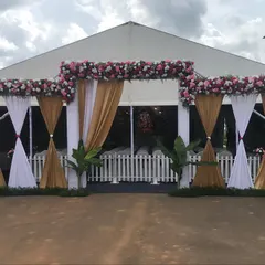 The entrance to the Ganesh Chaturthi celebration tent. We created an elegant entryway with white and gold drapes and a beautiful floral arch to welcome devotees into the sacred space.