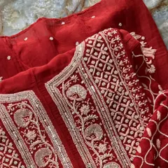 A detailed close-up of the neckline on our Sindoori Red Anarkali. This view highlights the precise hand-embroidery, combining traditional Chikankari with shimmering Kutdana and sequins.