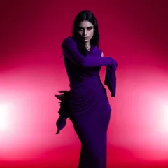 A dramatic shot for a fashion designer's collection. I created a smokey eye and styled the model's hair with wet, sculpted tendrils to match the avant-garde feel of the purple draped gown.