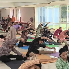 A dynamic group yoga session in progress. It's wonderful to see so many people moving together, stretching, and finding a moment of wellness in their busy day.
