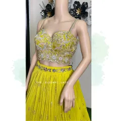 A detailed shot of the heavily embroidered bustier of my bright yellow lehenga. The intricate silver and floral threadwork makes it a standout piece, perfect for a festive Haldi or Sangeet night.
