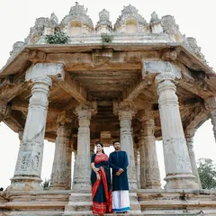 A majestic, wide-angle shot of a couple standing before the historic Melkote temple. I use grand architecture like this to create powerful, awe-inspiring portraits that celebrate both the couple and their heritage.
