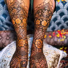 Your bridal look isn't complete without beautiful henna on your feet. I designed this symmetrical floral and mesh pattern to adorn the bride's feet, ensuring every detail is perfect.