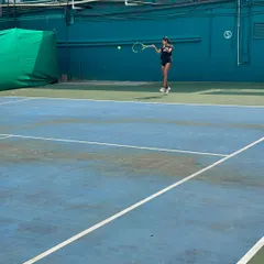 A young player executes a forehand during the Inter School Tennis Tournament. Our players are trained to perform in high-pressure competitive environments.