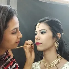 In action, applying the finishing touches to a client's lip makeup. My focus is always on precision and ensuring my client feels comfortable and happy.