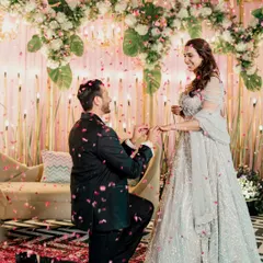 The classic proposal moment. The groom on one knee, presenting the ring under a shower of petals, is a memory I capture with all its romantic charm.