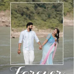 A timeless pre-wedding portrait of a couple walking hand-in-hand by the Ganga, showcasing a classic and romantic pose.
