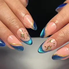 A beautiful blue cat eye effect used to create a modern French tip. I added tiny gold star charms and dots for an extra magical touch.