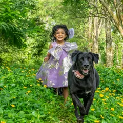 Running through a field of flowers with your best friend. This photo of Nitara and her dog Bagheera captures the freedom and joy of childhood. Outdoor sessions let kids and pets be their energetic, happy selves.
