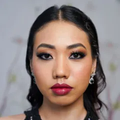 A direct, full-face view of a finished glam makeup application. The lashes are dense and long, creating a captivating frame for the eyes that is both elegant and striking.
