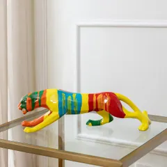 This abstract panther sculpture captures a sense of sleek movement. The body is decorated with bold, colorful stripes, making it a dynamic and artistic addition to a modern console table or glass shelf.