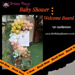 A close-up of a personalized baby shower welcome board. The sign is framed by a stylish balloon arrangement and rustic decorative elements, setting a warm and personal tone for the event.