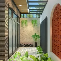 This narrow outdoor corridor was transformed into a bright and airy space with hanging plants and a glass ceiling. The patterned terracotta screen adds privacy and a decorative touch.