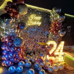 For a glamorous and high-energy celebration, I design photo backdrops like this full shimmer sequin wall. This 24th birthday setup includes large light-up marquee numbers, a 'Happy Birthday' neon sign, and a balloon garland with chrome, metallic, and disco ball accents for a party-ready look.