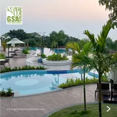 This resort-style pool deck features multiple interconnected pools, comfortable lounge seating, and lush tropical planting. Our design creates a luxurious and relaxing environment, perfect for a holiday home township or a high-end residential club.