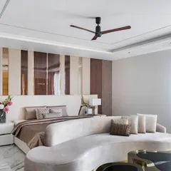 A master bedroom that settles in softly but leaves a mark. This space in our Chennai project is layered with form, rhythm, and restraint, featuring a curved sofa at the foot of the bed and a striking wall panel of wood and lacquer.