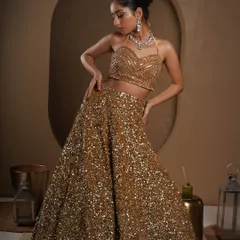A full-length shot of a stunning sequined lehenga. My goal here was to capture the way the garment glitters under studio lights while showcasing its elegant silhouette and the model's graceful pose for a designer lookbook.