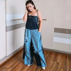 This edgy, deconstructed denim jumpsuit is a true fashion statement. I help clients find and style unique pieces like this that push boundaries and express a bold personality.