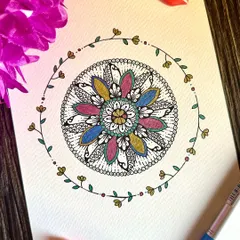 This floral mandala is surrounded by a delicate, hand-drawn vine. The soft colors and nature-inspired elements combine to create a piece that feels like a gentle breath of fresh air.