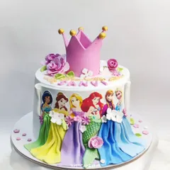 This Disney princess cake features a beautiful arrangement of characters around the side, with a delicate crown on top. The flowing fondant dresses and flowers are all handcrafted.