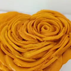 Here is a close-up of the detail in the mango rose topping. This view highlights the delicate craftsmanship and the freshness of the ingredients I use in my signature no-bake cheesecakes.