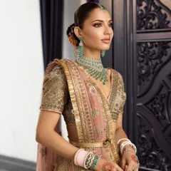 This is the complete look for my beautiful bride Vidushi. We aimed for traditional elegance with a modern feel, using a soft, glowing base and defined eyes to complement her pastel JJ Valaya outfit.