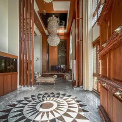 We designed this custom mandala floor inlay in black and grey marble for the entrance foyer. This bespoke feature demonstrates our commitment to detailed craftsmanship and creating unique, personalized design elements.