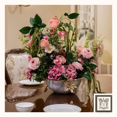 A beautiful floral arrangement can transform a room. This luxurious centerpiece, with its mix of pinks and greens, is designed to bring timeless elegance to a dining or console table, making any gathering feel more special and sophisticated.