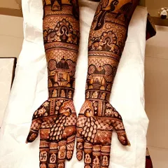 An example of a grand, full-coverage bridal design. We've included temple motifs, peacocks, and intricate jaal (net) patterns to create a truly royal look.