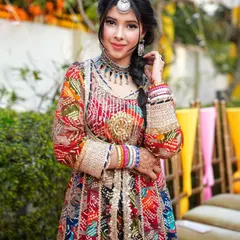 Perfect for a mehendi or sangeet, this colorful bandhani print anarkali is styled with a maang tikka and braided hair. This type of content is ideal for brands focusing on Indian wedding fashion.