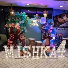 We brought the Masha and the Bear cartoon to life with this detailed setup. It features character cutouts, a custom balloon tree, log-style cake stands, large marquee letters for the name and age, and a neon "Happy Birthday" sign for the photo backdrop.