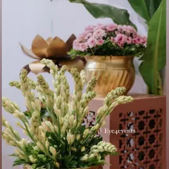 A close-up of our ethnic side decor. This arrangement features tuberose and pink carnations in ornate brass pots, placed on a decorative stand to add a touch of traditional elegance to any corner.