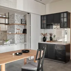 Set next to the kitchen, this compact bar commands attention with its striking beveled mirror backsplash. Under-counter storage and wall cabinets in a sleek black matte finish add both style and functionality for entertaining.