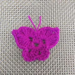 A single butterfly applique. This versatile piece can be made into a keychain, hairclip, bookmark, or anything else you can imagine.
