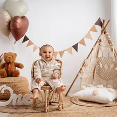 A classic first birthday portrait in my boho-themed setup. The neutral tones, teddy bear, and mini teepee create a warm and stylish scene for this happy one-year-old.