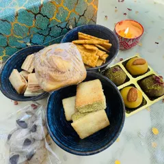 My premium "Swaad-e-Diwali" gift hamper is a feast for the senses. It includes a wide assortment of my fusion and classic treats, like Nankhatai Sandwiches, Besan Laddoos, and a Marbled Biscoff Cube Cake.