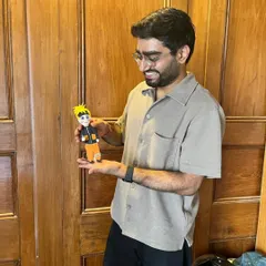 A participant proudly holds up his handmade Naruto figurine. Our workshops are a space to bring your favorite characters and ideas to life in clay.