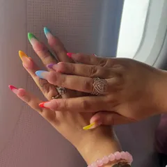 Getting ready for a vacation? I created these fun, colorful vacation nails using a rainbow gradient on the tips for a modern twist on the classic French manicure.