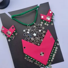 I love working with bright colours, and this pink and green fabric necklace set is a perfect example. It features a large mirror work pendant and matching earrings with ghungroos, making it a true statement piece for any celebration.