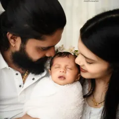 A beautiful close-up of new parents admiring their sleeping baby. The image is full of tenderness, highlighting the delicate features of the newborn and the parents' adoration.