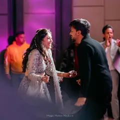 A candid moment of joy between the bride and groom during their sangeet performance. We focus on creating choreography that allows for these spontaneous, happy interactions.