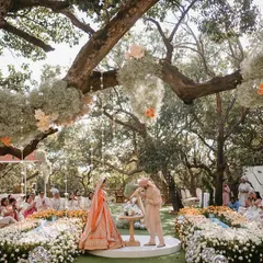 A wedding ceremony should feel like it’s floating on air. For Aashna and Armaan, we created a circular aisle enveloped by an ombré wave of thousands of roses, with baby's breath clouds hanging from the trees above. This was the setting for their sand ceremony, a beautiful symbol of two lives blending into one.
