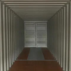 Looking down the length of an empty container, you can appreciate its significant volume and secure, enclosed design. The double doors at the end provide a wide access point for large items.