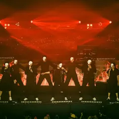 The power of formation and costume in a live concert setting. For this piece, we used stark black outfits and masks under dramatic red lighting to create a powerful and memorable visual statement.
