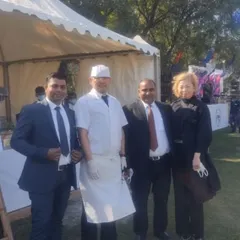 Our team on the ground. Here are some of our managers and chefs posing with a client at an outdoor event, ensuring everything runs perfectly.