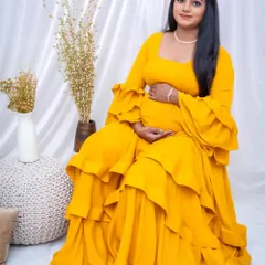 A radiant mother-to-be in our vibrant yellow tiered maternity gown. The ruffled sleeves add a touch of playfulness.
