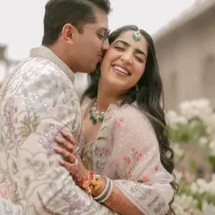 Pure, unadulterated happiness. This candid moment captures the essence of a pastel-themed celebration. The couple's coordinated Rahul Mishra outfits and the soft, natural light create a picture of effortless romance.