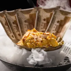 Our iconic Daulat ki Chaat, an airy milk-based dessert, arrives at the table shrouded in dramatic smoke. It's a multi-sensory experience that is as delightful to watch as it is to eat.