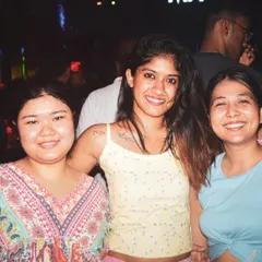Friends smiling and posing for a photo on the dance floor. I provide the soundtrack for great memories and fun nights out.