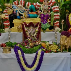 A closer view of the offerings and the beautifully draped deity. Each element is arranged with love and reverence for the festival.